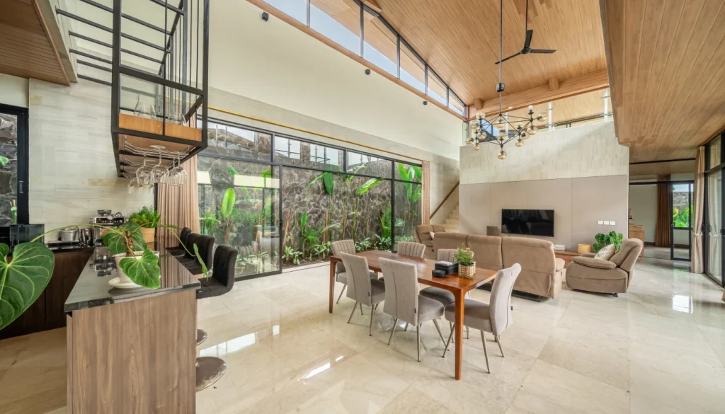 Modern, open-plan living area at The Reset Bali, featuring natural light, indoor greenery, and luxury furnishings.